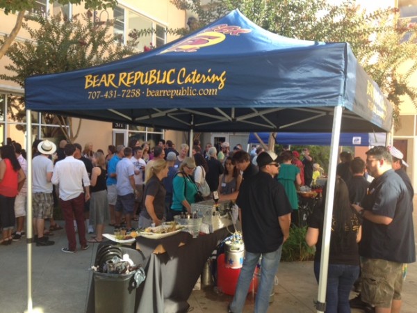 Attendees flock to beer stands at Bear Republic Brewing Co.'s 6th Annual Cellar Party on Sunday next to its brewpub in Healdsburg.